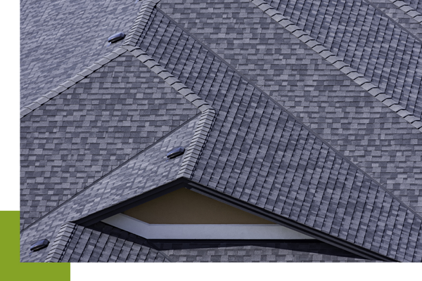 A sprawling roof displaying shingles in very good condition.