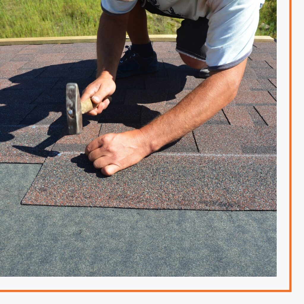 Man nailing down shingles