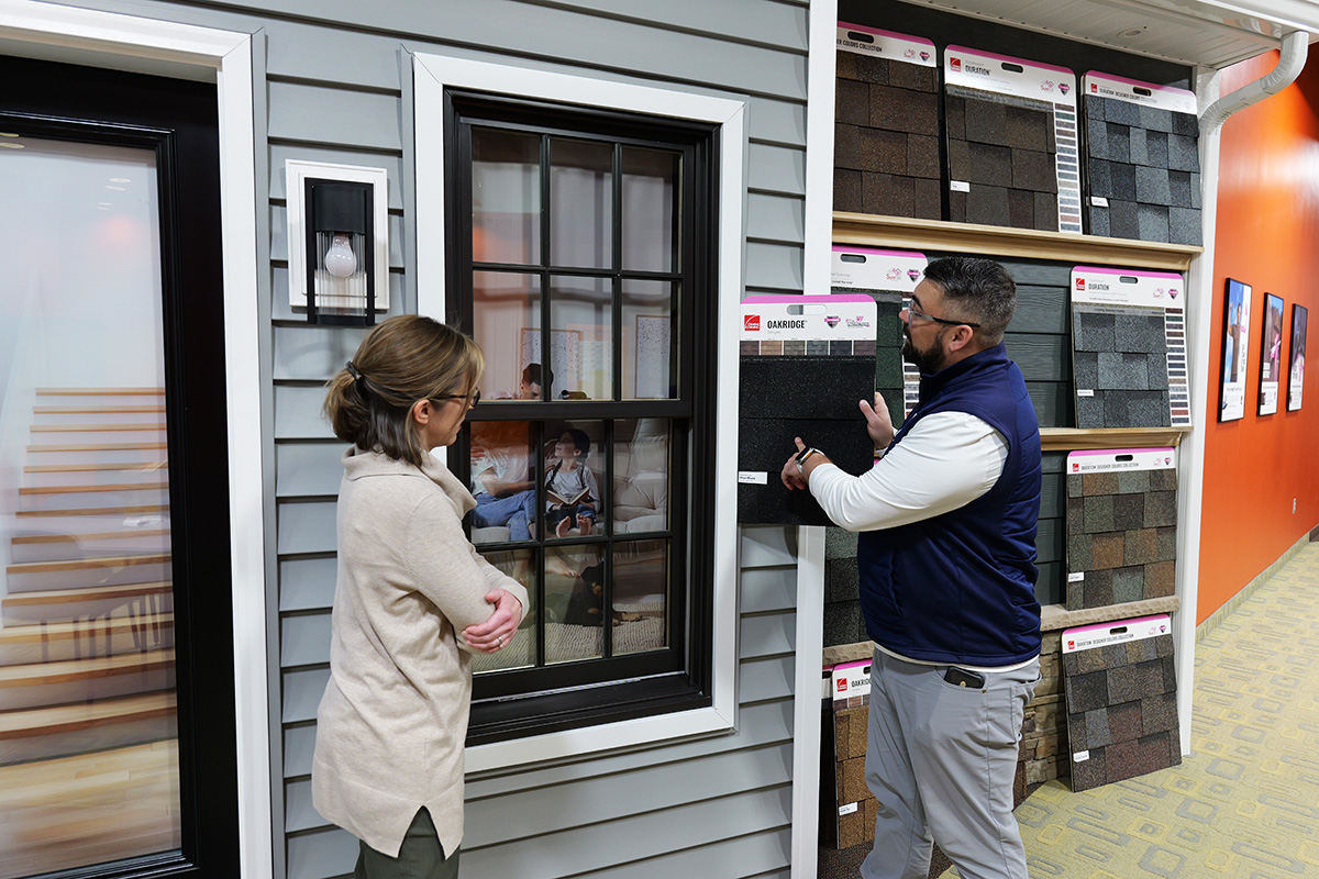 Homeowner learning about siding installation & replacement