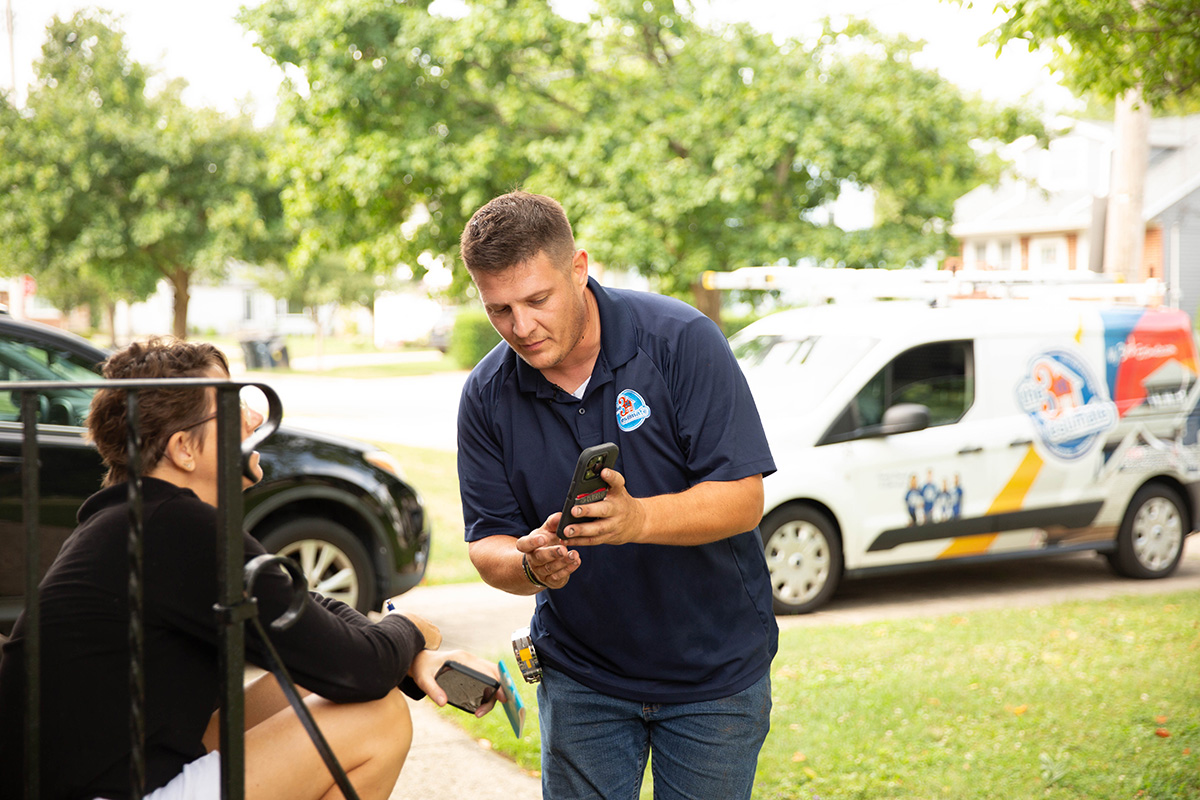 The Third Estimate sales rep communicating results of roof inspection services to homeowner