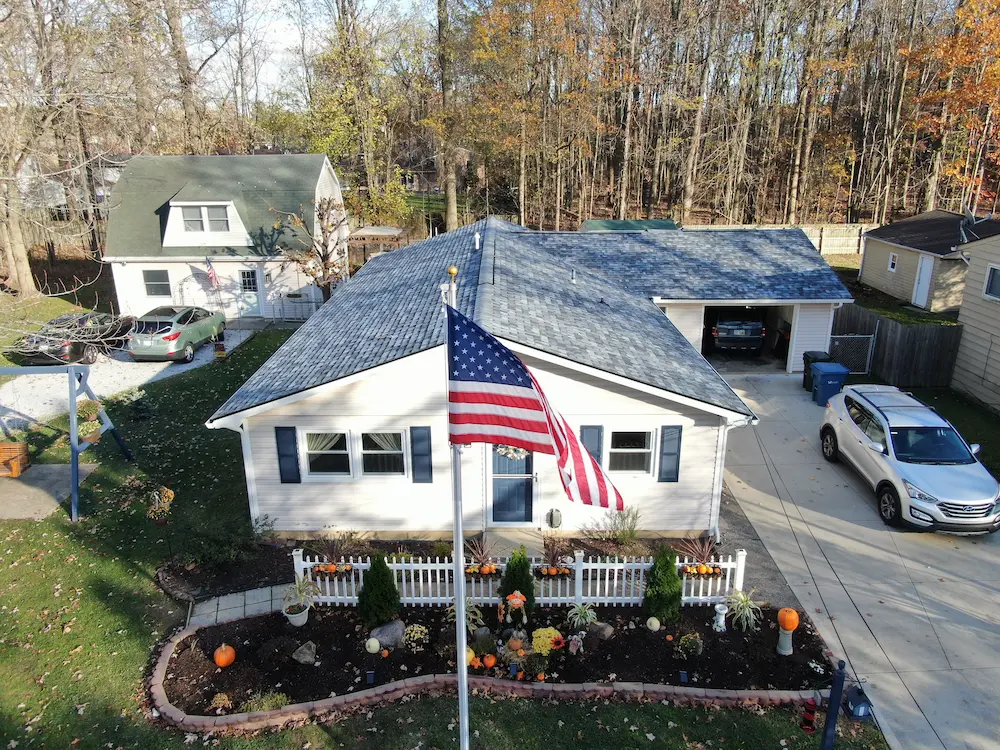 Chapman After Photo House with new roof and American flag
