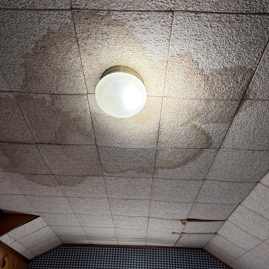 The Third Estimate crew inspecting water damage from the ceiling of the house in Amherst, OH.